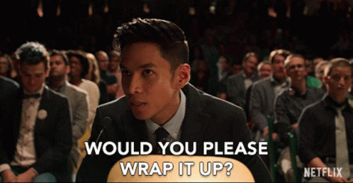 A Man In A Suit And Tie Stands In Front Of A Crowd Asking If They Would Please Wrap It Up GIF