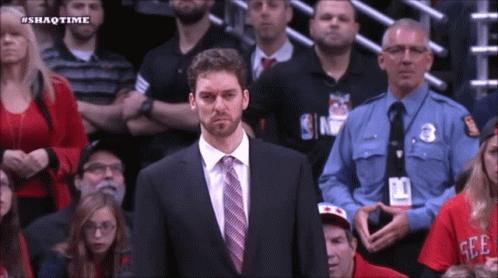 A Man In A Suit And Tie Stands In Front Of A Crowd With The Hashtag Shaqtime On The Bottom GIF