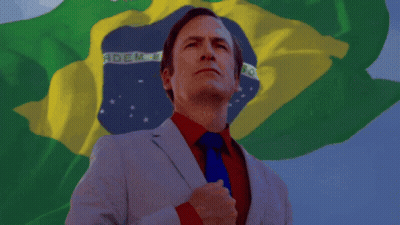 A Man In A Suit And Tie Stands In Front Of A Flag That Says Brasil GIF