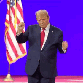 A Man In A Suit And Tie Stands In Front Of A Flag GIF