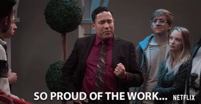 A Man In A Suit And Tie Stands In Front Of A Group Of People And Says So Proud Of The Work Netflix GIF