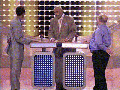 A Man In A Suit And Tie Stands In Front Of A Podium With A Blue Light On It That Says 00 GIF