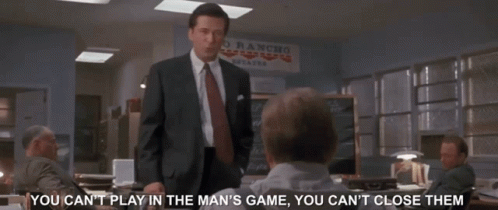 A Man In A Suit And Tie Stands In Front Of A Sign That Says " Rio Rancho " GIF
