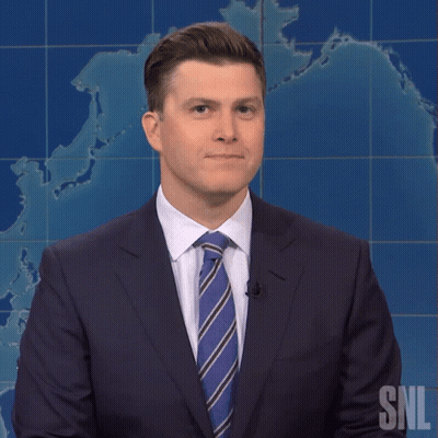 A Man In A Suit And Tie Stands In Front Of A Snl Map GIF