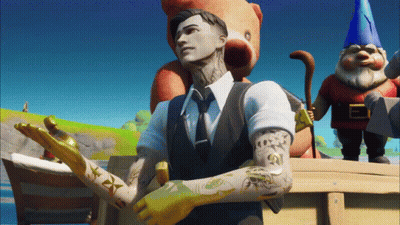A Man In A Suit And Tie Stands In Front Of A Teddy Bear And A Gnome GIF