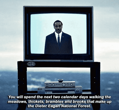 A Man In A Suit And Tie Stands In Front Of A Television Which Says You Will Spend The Next Two Calendar Days GIF