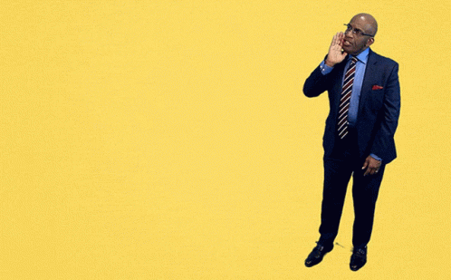 A Man In A Suit And Tie Stands In Front Of A Yellow Sign That Says Sunday Sunday Sunday GIF
