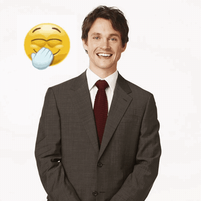 A Man In A Suit And Tie Stands In Front Of A Yellow Smiley Face GIF