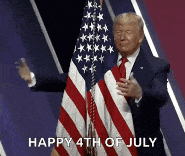A Man In A Suit And Tie Stands In Front Of An American Flag And Says " Happy 4Th Of July " GIF