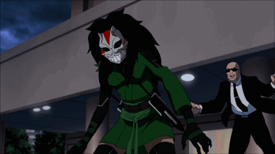 A Man In A Suit And Tie Stands Next To A Cartoon Character In A Mask GIF