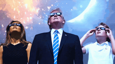 A Man In A Suit And Tie Stands Next To A Woman And A Child Wearing Sunglasses GIF