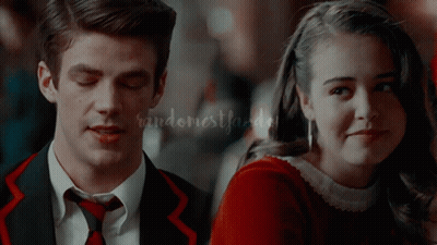 A Man In A Suit And Tie Stands Next To A Woman In A Red Dress With Randomestflasher Written On The Bottom GIF