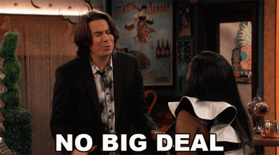 A Man In A Suit And Tie Stands Next To A Woman In A White And Black Dress And Says No Big Deal GIF