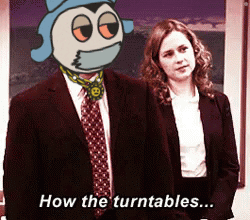 A Man In A Suit And Tie Stands Next To A Woman With The Words How The Turntables Written Below Him GIF