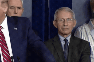 A Man In A Suit And Tie Stands Next To Another Man In A Suit GIF