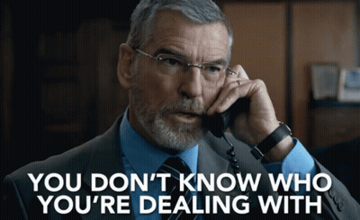 A Man In A Suit And Tie Talking On A Phone With The Words " You Don 'T Know Who You 'Re Dealing With " GIF
