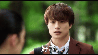 A Man In A Suit And Tie Talks To A Woman In A Park GIF