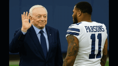 A Man In A Suit And Tie Waves To A Man In A Number 11 Parsons Jersey GIF
