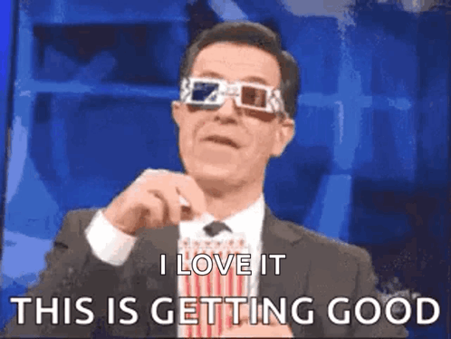 A Man In A Suit And Tie Wearing 3D Glasses Is Saying I Love It This Is Getting Good . GIF