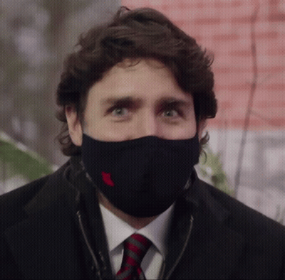 A Man In A Suit And Tie Wearing A Black Mask GIF