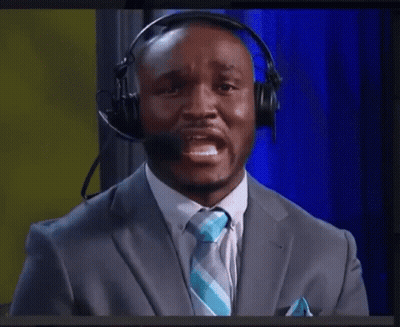 A Man In A Suit And Tie Wearing A Headset GIF
