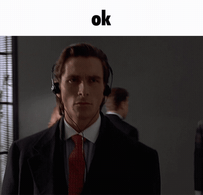 A Man In A Suit And Tie Wearing Headphones With The Word Ok Above Him GIF