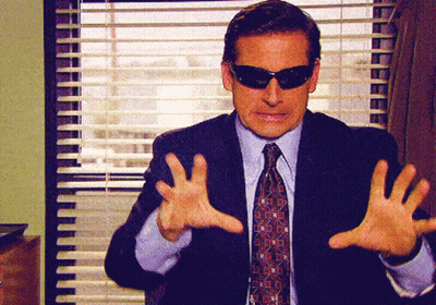 A Man In A Suit And Tie Wearing Sunglasses GIF