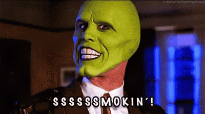 A Man In A Suit And Tie With A Green Mask On His Face Says Sss Smokin ' GIF