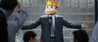 A Man In A Suit And Tie With A Monkey Mask On His Head GIF