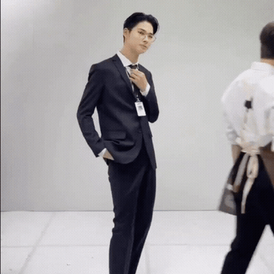 A Man In A Suit And Tie With A Name Tag That Says ' A. ' On It GIF