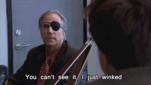 A Man In A Suit And Tie With A Patch On His Eye Is Talking To Another Man . GIF