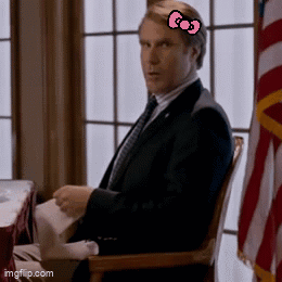 A Man In A Suit And Tie With A Pink Hello Kitty Bow On His Head GIF