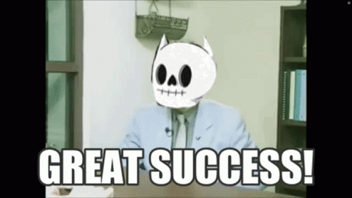 A Man In A Suit And Tie With A Skull On His Head Says Great Success . GIF