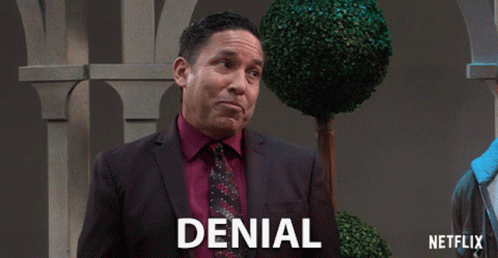 A Man In A Suit And Tie With Denial Written On The Bottom GIF