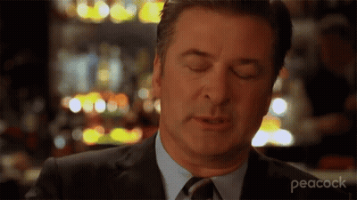 A Man In A Suit And Tie With His Eyes Closed GIF