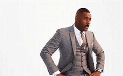 A Man In A Suit And Tie With His Hands On His Hips . GIF