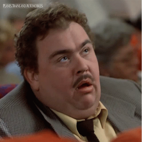 A Man In A Suit And Tie With Planes Trains And Automobiles On The Bottom GIF