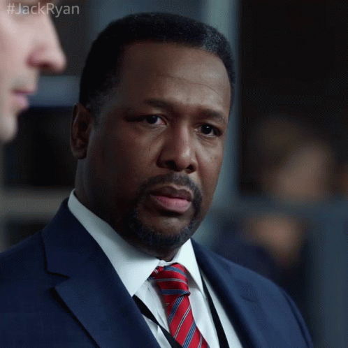 A Man In A Suit And Tie With The Hashtag #Jackryan On The Bottom GIF