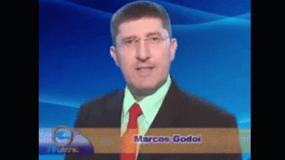 A Man In A Suit And Tie With The Name Marcos Godoi On The Bottom Right GIF