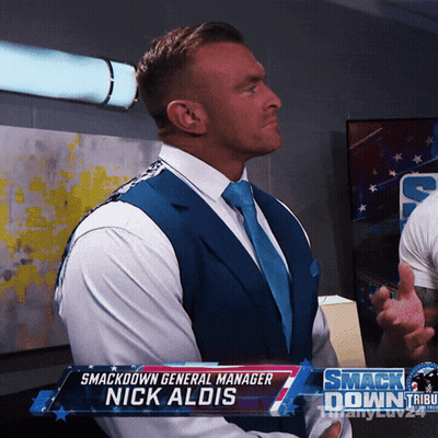 A Man In A Suit And Tie With The Name Nick Aldis GIF