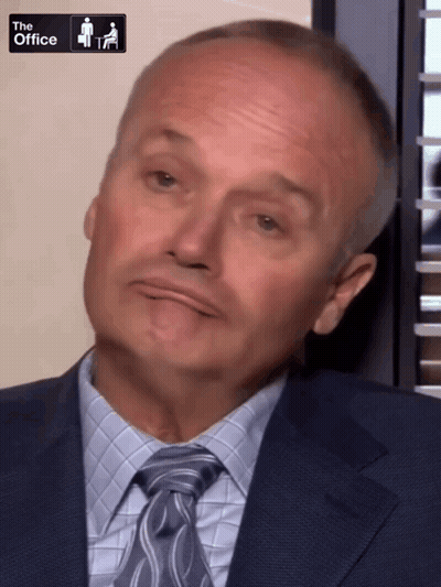 A Man In A Suit And Tie With The Office Logo On The Bottom GIF