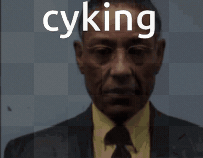 A Man In A Suit And Tie With The Word Cyking On His Face GIF