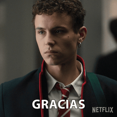 A Man In A Suit And Tie With The Word Gracias Written Below Him GIF