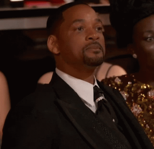 A Man In A Suit And Tie With The Word Yes On His Face GIF