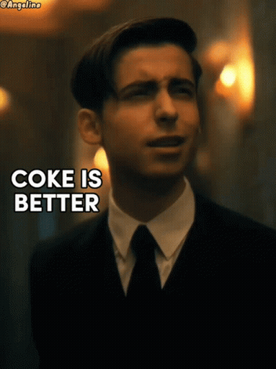 A Man In A Suit And Tie With The Words Coke Is Better GIF