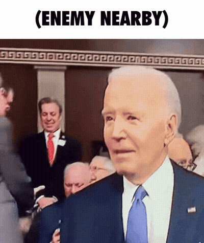 A Man In A Suit And Tie With The Words Enemy Nearby Written Below Him GIF