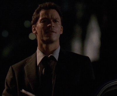 A Man In A Suit And Tie With The Words Go With God On The Bottom GIF