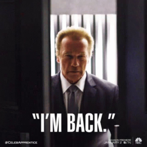 A Man In A Suit And Tie With The Words " I 'M Back " GIF