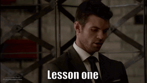 A Man In A Suit And Tie With The Words Lesson One On His Face GIF