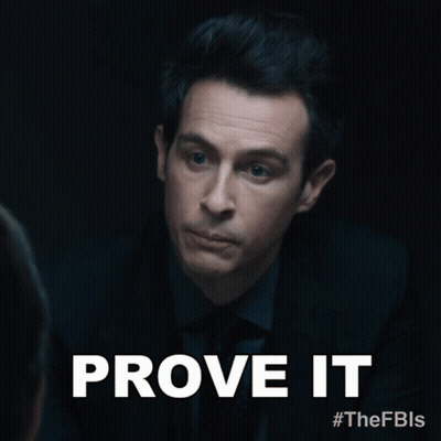 A Man In A Suit And Tie With The Words Prove It Above Him GIF